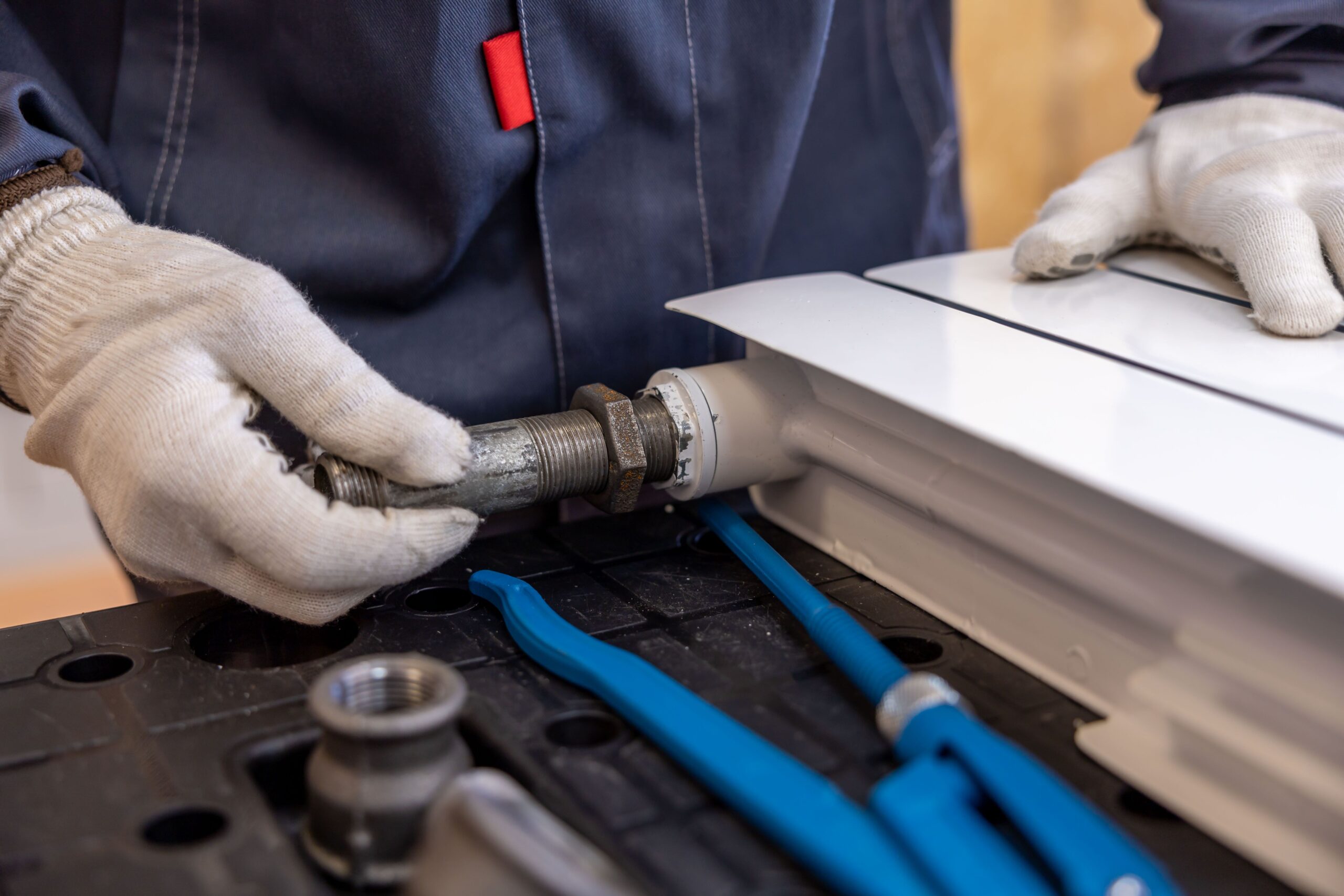 boiler service surrey - A-Man-Repairing-The-Pipe